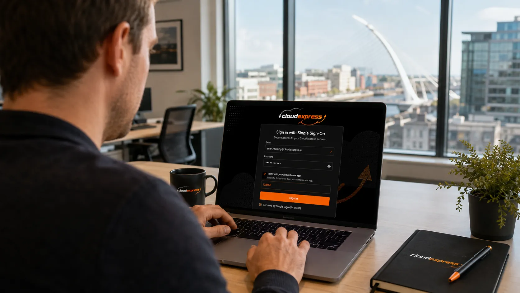 Office worker logging into laptop using single sign-on authentication in a modern Irish workplace